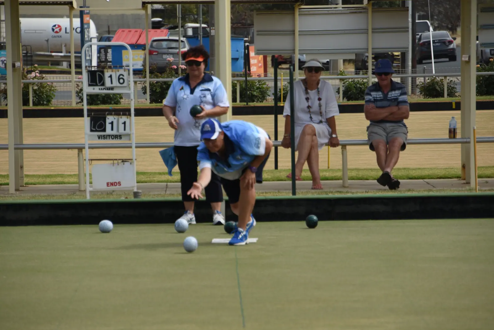 A wide view of a championship end with bowls clustered around the jack
