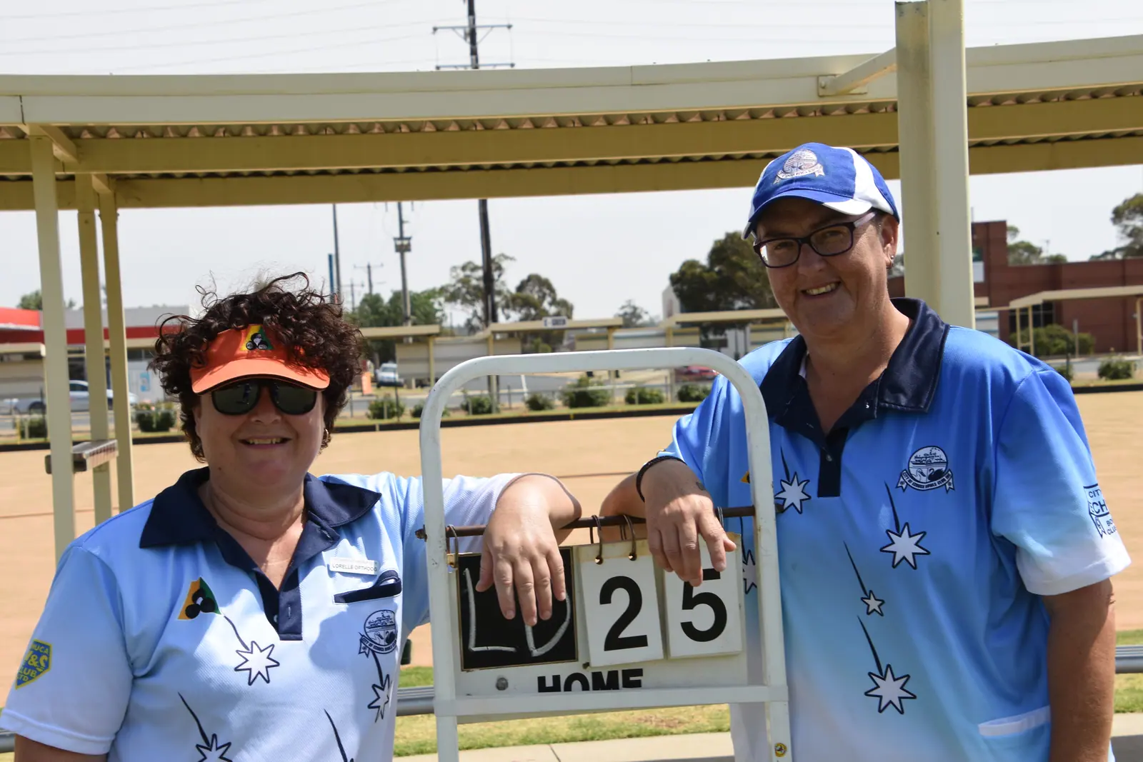 Two club members in Echuca colours after a championship match