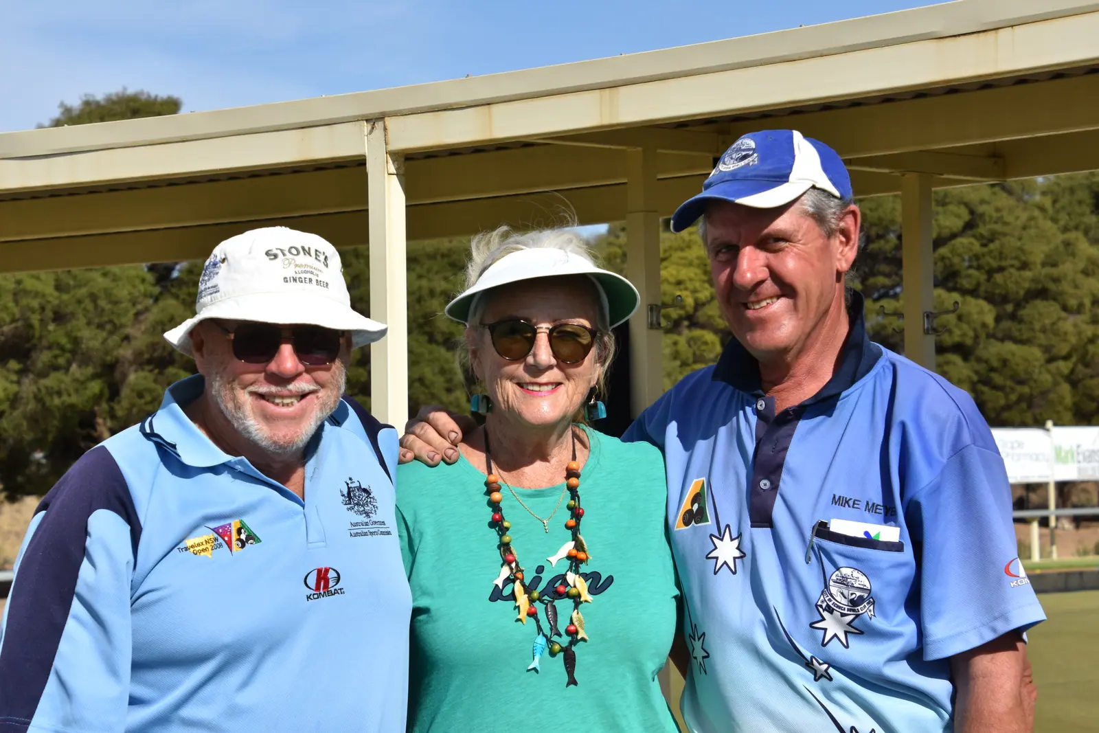 Three members in club uniform posing together on tournament day