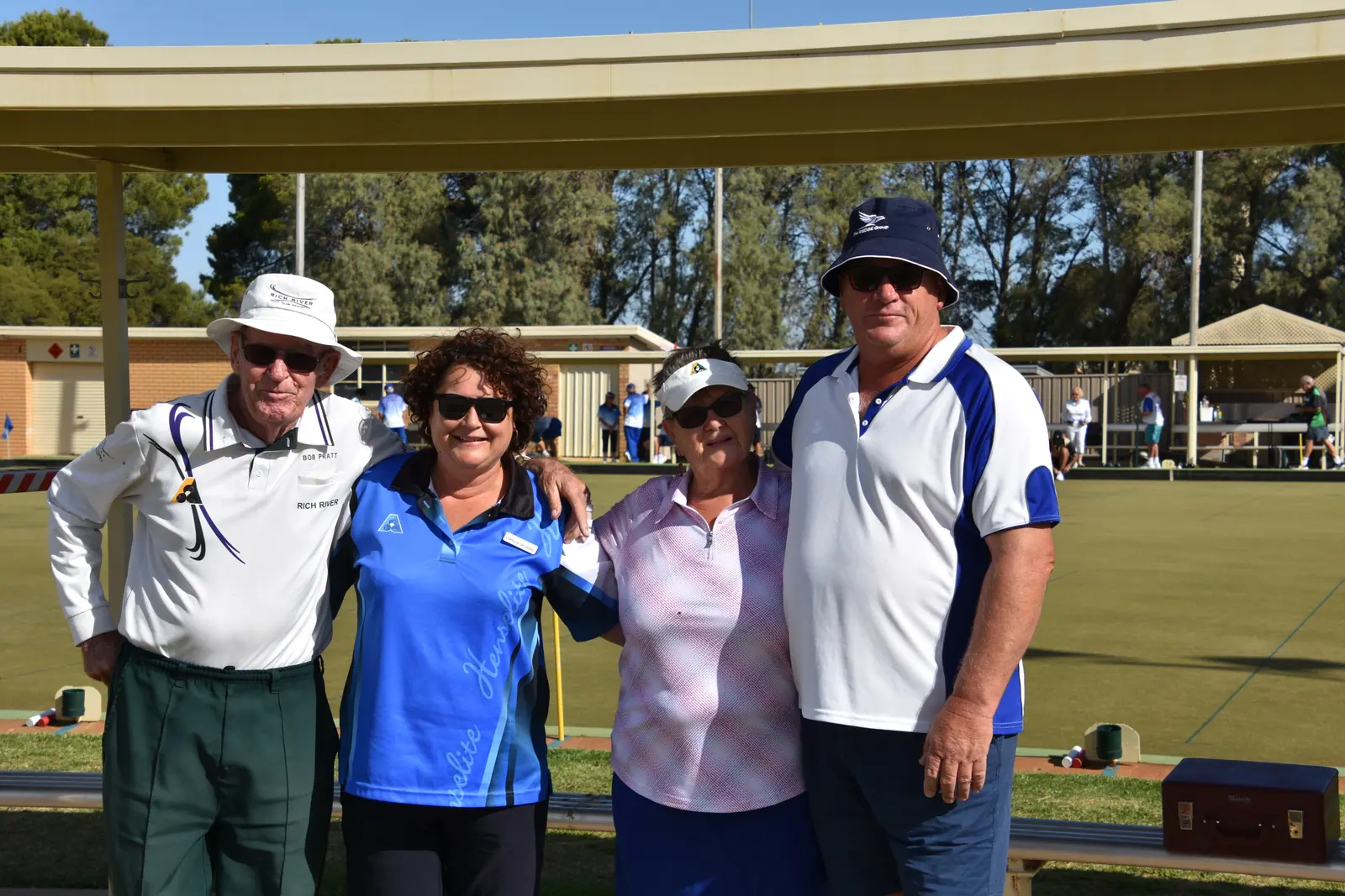 A group of visiting and Echuca players together beside the green