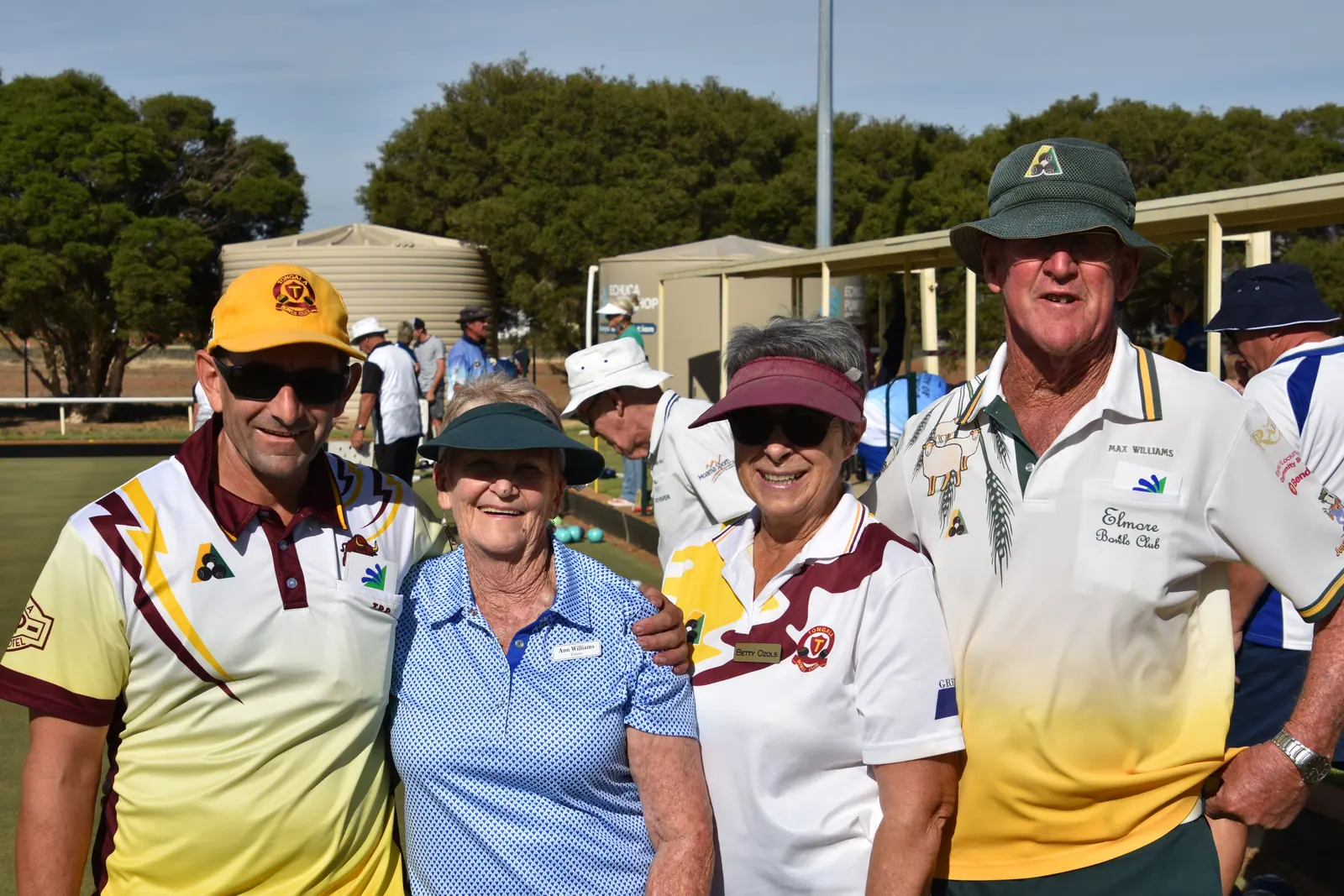 Members in hats and club shirts gathered for a tournament photograph