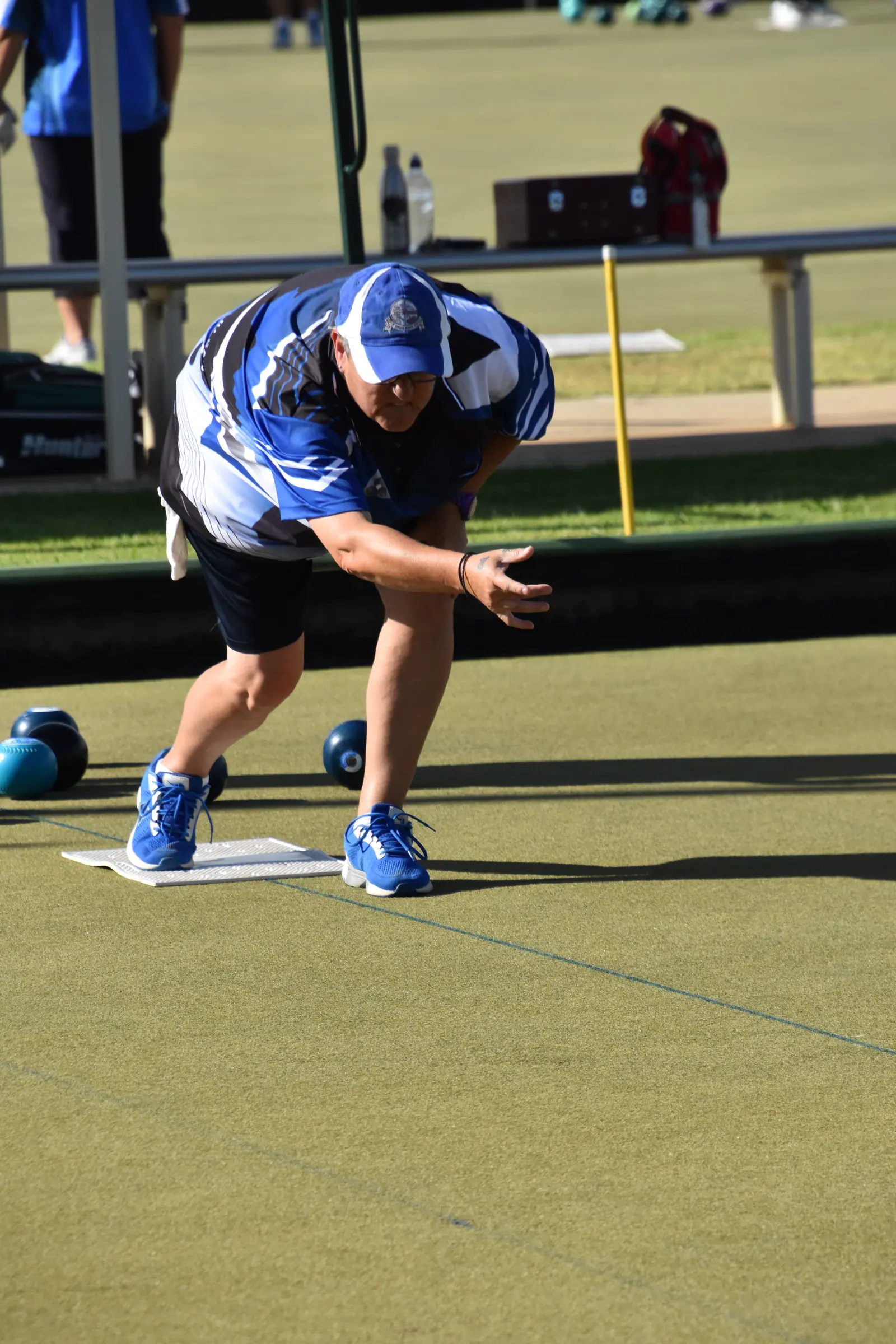 A bowler in the delivery crouch during a tournament match